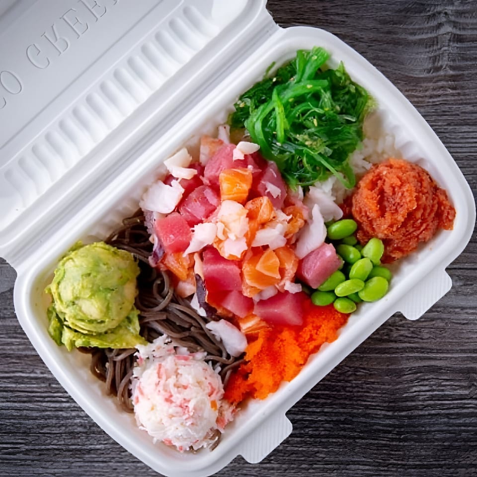 A colorful Poke Rainbow bowl with tuna, salmon, crab, avocado, seaweed, edamame, and roe.