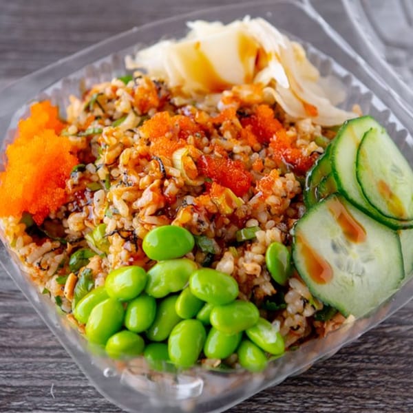 Poke Rainbow poke bowl with rice, edamame, cucumber, fish roe, and pickled ginger.
